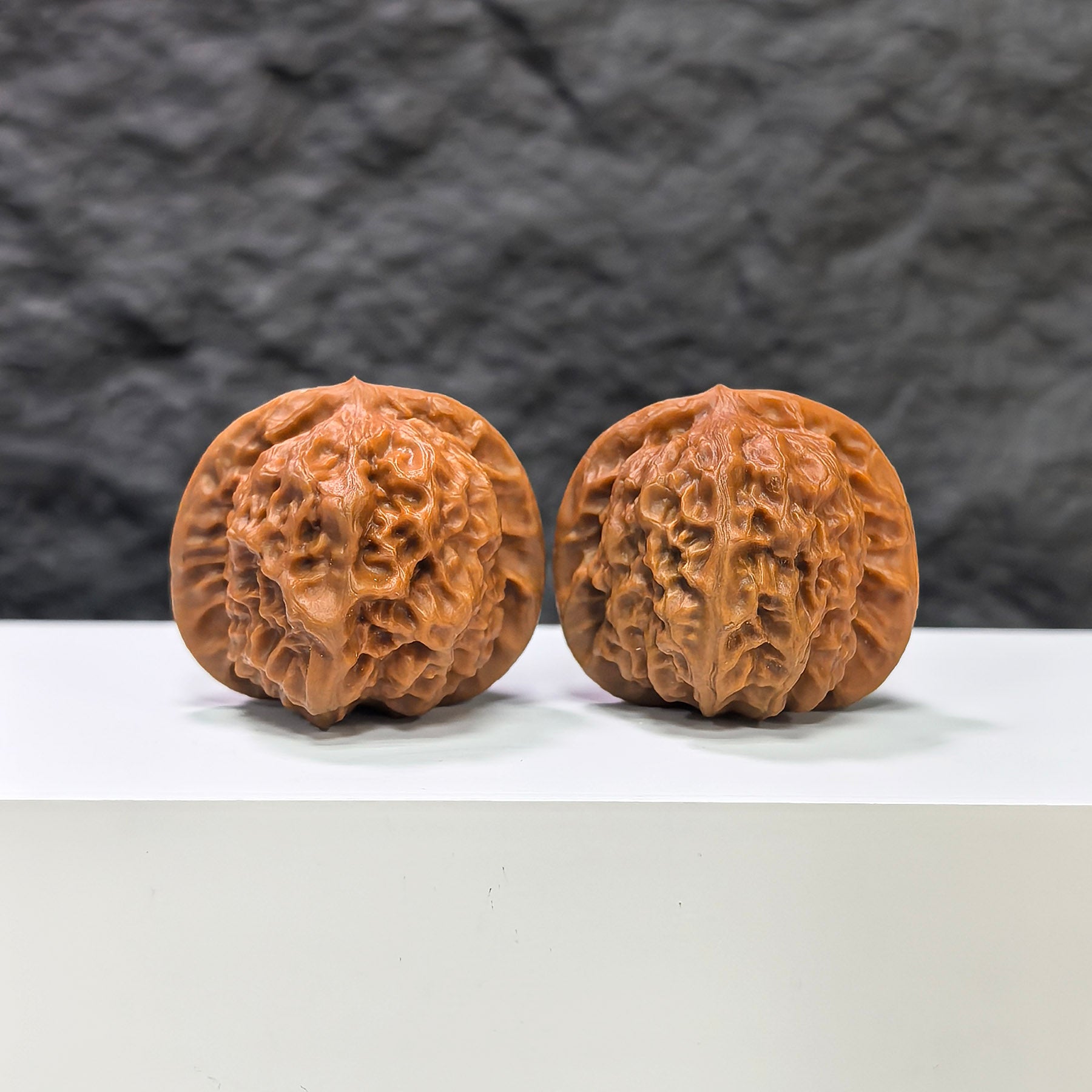 Pair of porcelain doll Wenwan walnuts by Wenwan Art, smooth-glaze finish, 38mm size, featuring detailed doll designs.
