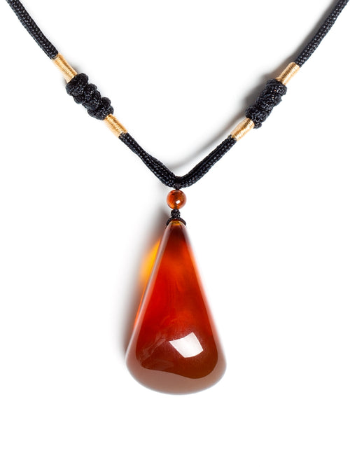Natural brownish-red freeform amber pendant displaying smooth, polished surface with warm amber tones and unique organic shape.