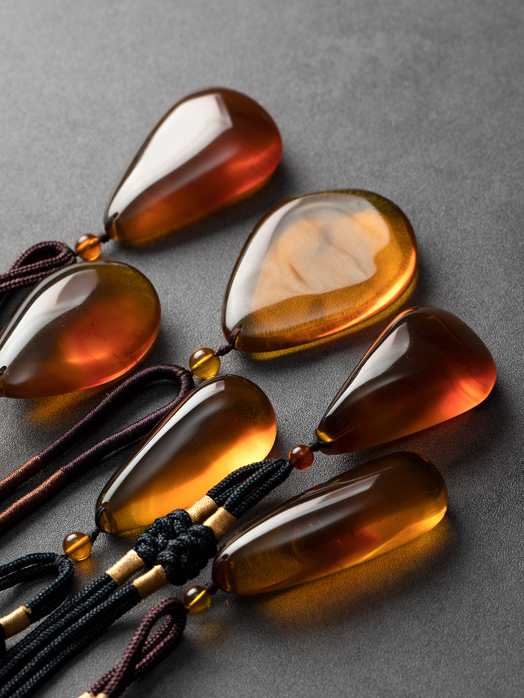 Authentic brownish-red freeform amber pendant with natural Myanmar amber, weighing 12g, displayed with intricate details and warm tones.