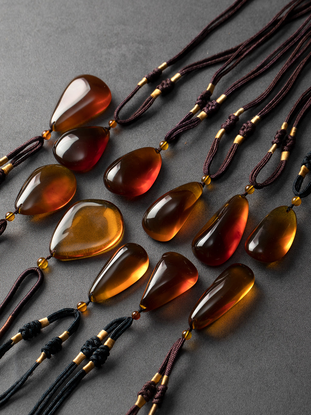 Authentic brownish-red freeform amber pendant with natural Myanmar amber, showcasing a polished, irregular shape and warm glow.