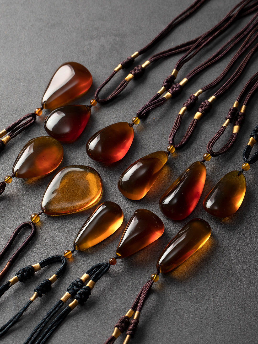 Authentic brownish-red freeform amber pendant with natural Myanmar amber, showcasing a polished, irregular shape and warm glow.