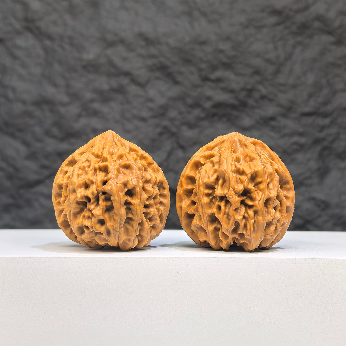 Golden Taurus Wenwan Walnut pair from Wenwan Art, 36mm x 35mm, featuring smooth, polished natural walnut carvings with intricate details.