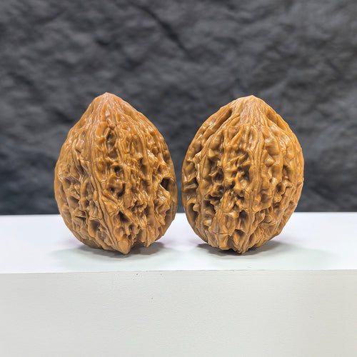 Pair of Beijing Chicken Heart Wenwan walnuts by Wenwan Art, 39mm, showcasing intricate natural wood grain and rich textures.