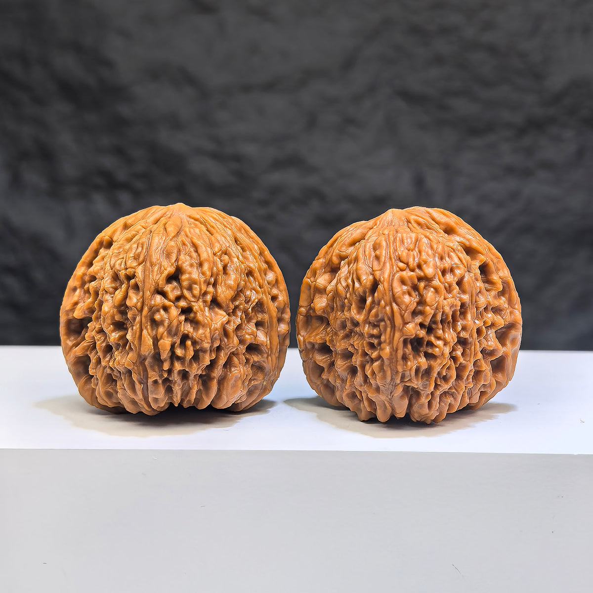 Pair of Red Shell Nanjiangstone Wenwan walnuts from Wenwan Art, 40mm x 38mm, featuring vibrant red shells and intricate natural textures.