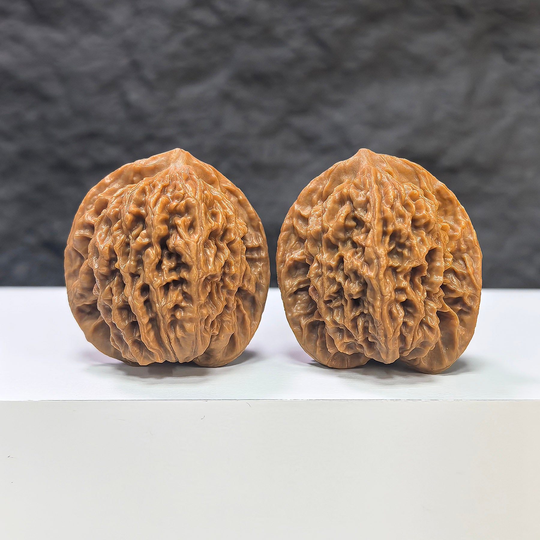 Pair of Panlong Texture Wenwan walnuts from Wenwan Art, featuring detailed natural wood grain patterns, measuring 34mm x 31mm.