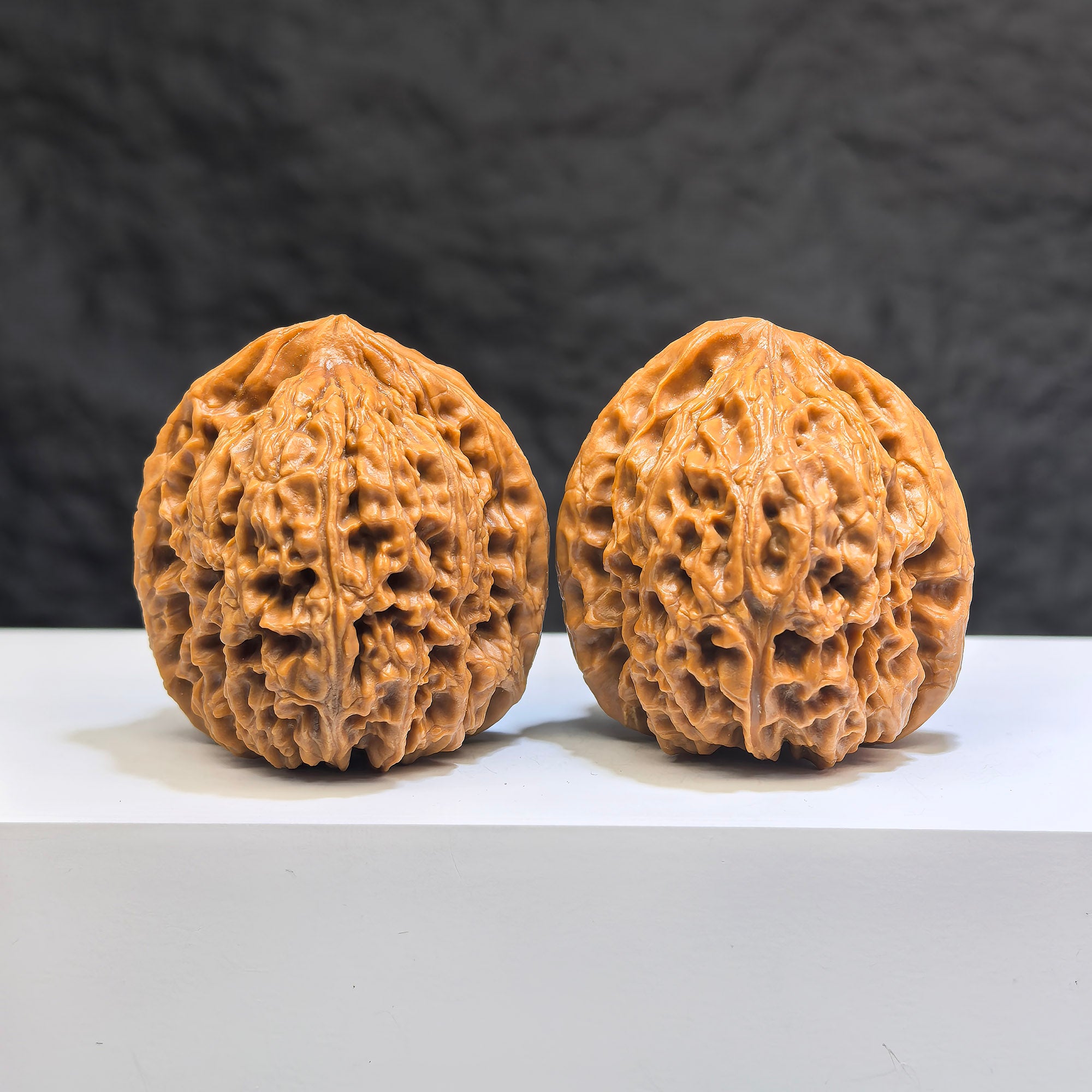 Pair of Nanjiangstone Wenwan walnuts from Wenwan Art, 38mm x 39mm, showcasing smooth, polished walnut carvings with intricate details.