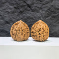 Pair of Kylin Texture Wenwan Walnut carvings by Wenwan Art, featuring 麒麟紋 pattern, 39mm x 35mm, detailed and textured surface.