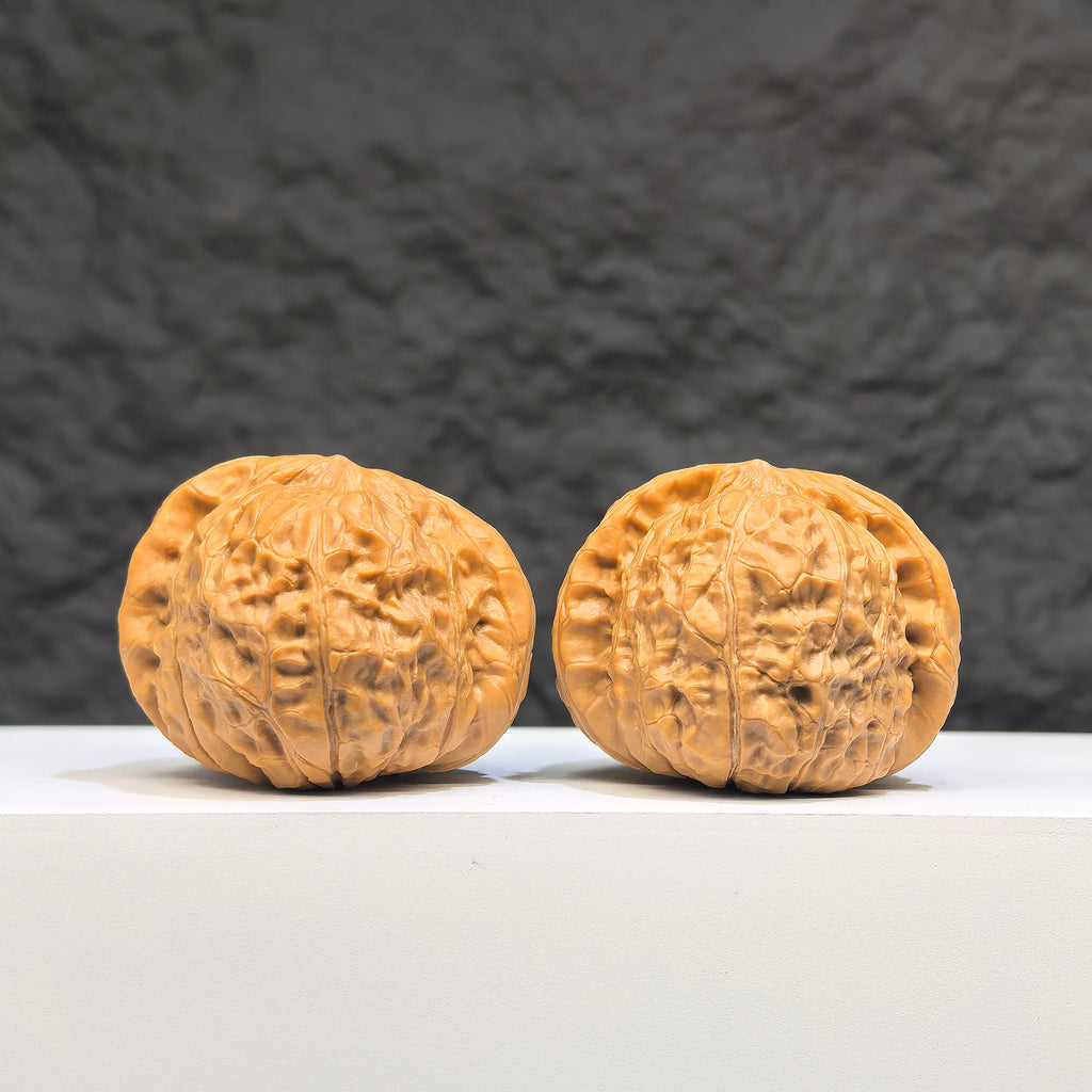 Pair of Hundred Beasts Lion Head Wenwan Walnuts from Wenwan Art, 43mm x 40mm, showcasing detailed carved lion head designs.