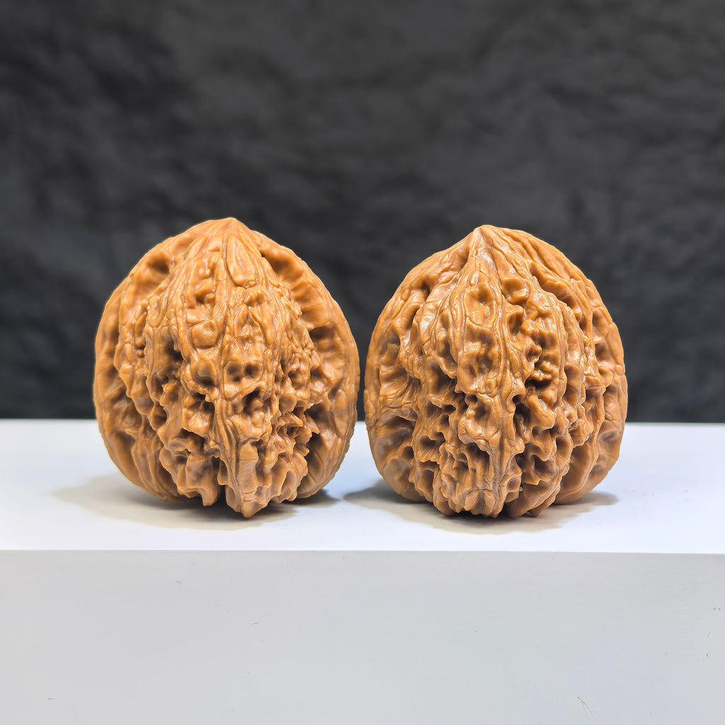 Pair of Nanjiangstone Wenwan walnuts from Wenwan Art, 36mm each, showcasing natural stone textures and detailed craftsmanship.