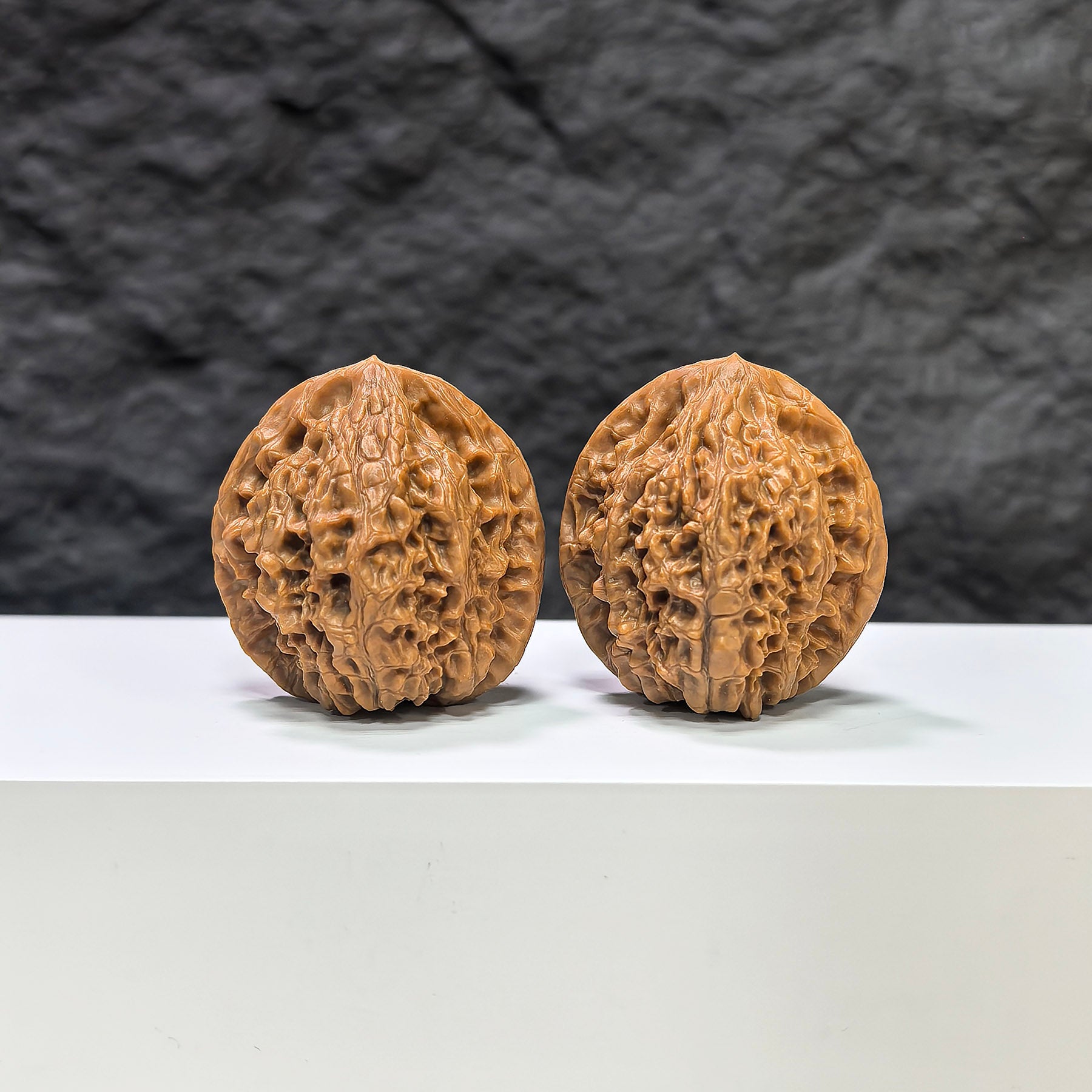 Pair of Golden Kylin Wenwan walnuts from Wenwan Art, featuring natural golden-colored walnut shells, 36mm x 34mm.