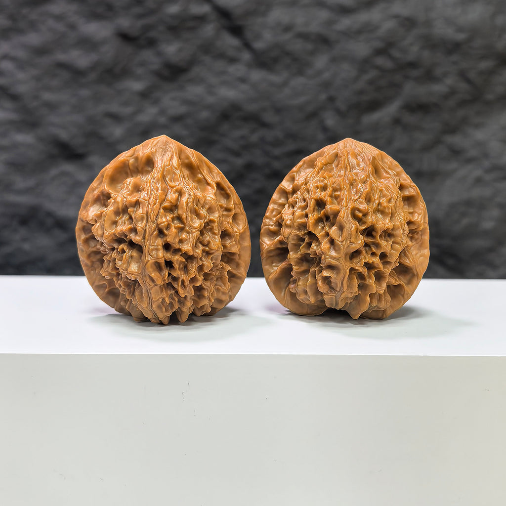 Pair of Golden Kylin Wenwan walnuts from Wenwan Art, 40mm x 38mm, showcasing detailed natural walnut carvings and golden accents.