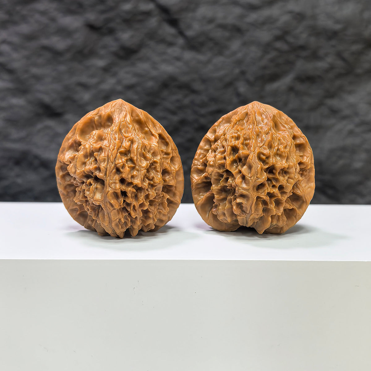 Pair of Golden Kylin Wenwan walnuts from Wenwan Art, 40mm x 38mm, showcasing detailed natural walnut carvings and golden accents.