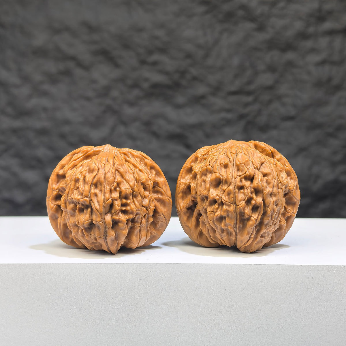 Pair of Wenwan Art Millstone Classic Wenwan walnuts, 38mm x 34mm, with detailed carvings and smooth polished surfaces.