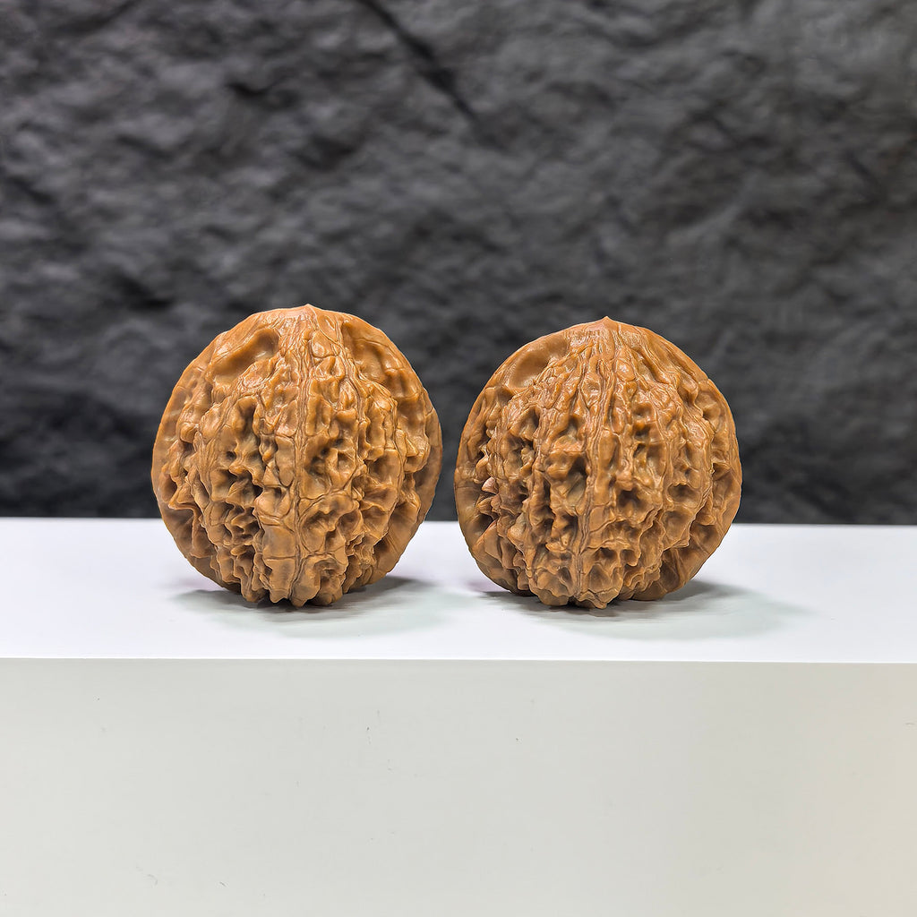 Pair of Golden Kylin Wenwan Walnuts by Wenwan Art, 36mm, featuring intricate natural carvings on smooth wood.