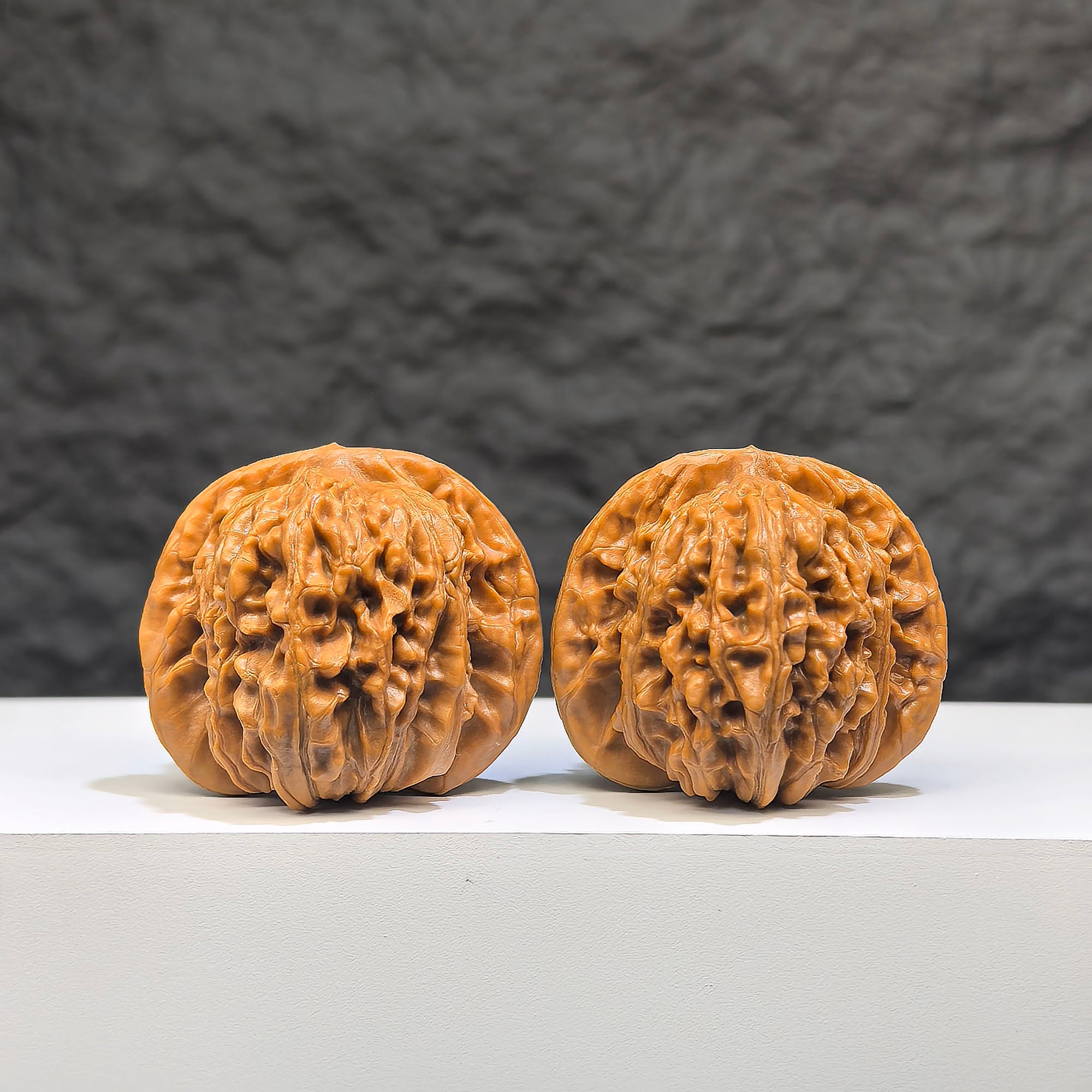 Pair of Sizuolou Wenwan Walnuts by Wenwan Art, 40mm x 37mm, showcasing smooth, polished classic Wenwan walnut carvings.