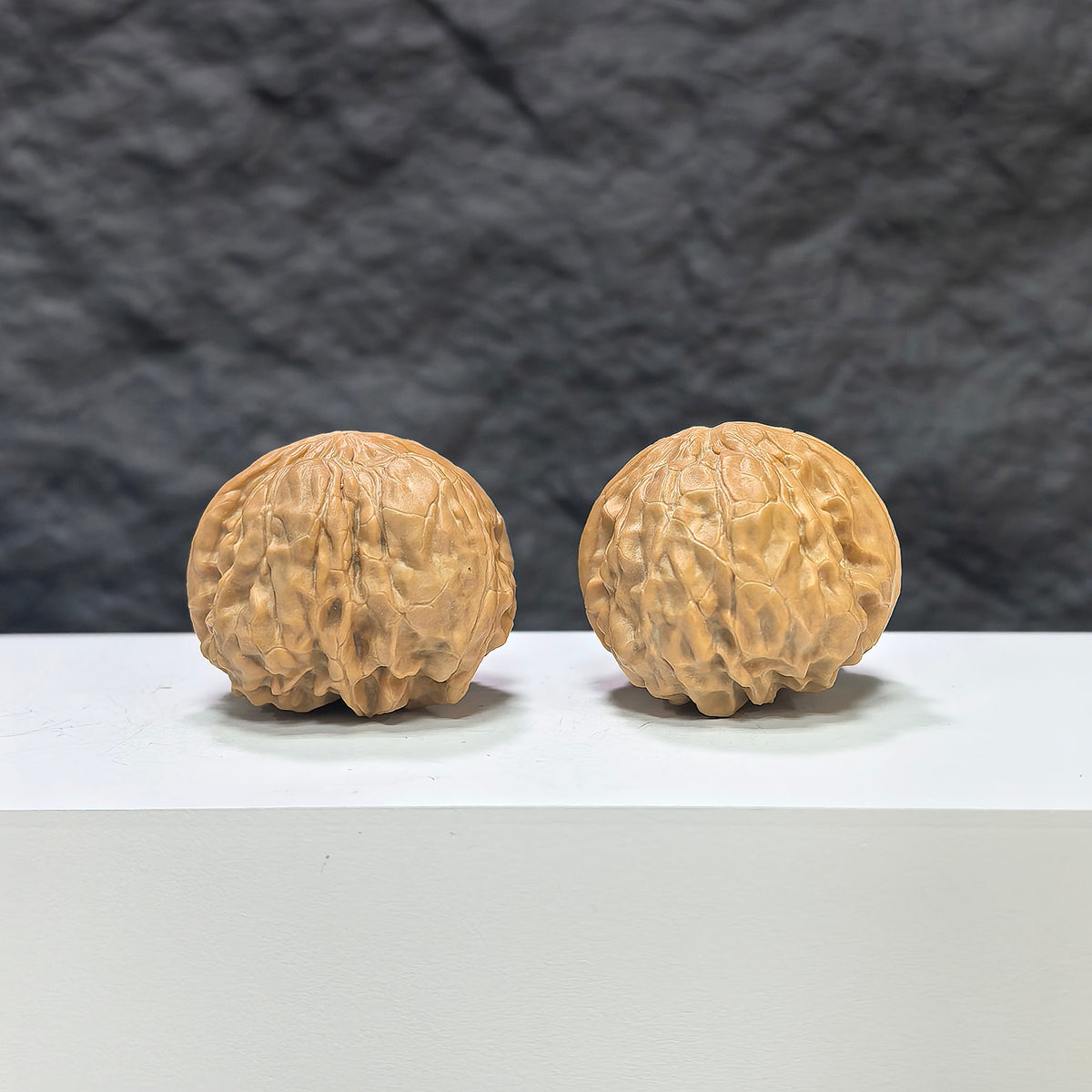 Pair of Golden Toad Vessel Wenwan Walnut carvings by Wenwan Art, featuring detailed golden toad and vessel designs, measuring 35x38mm.