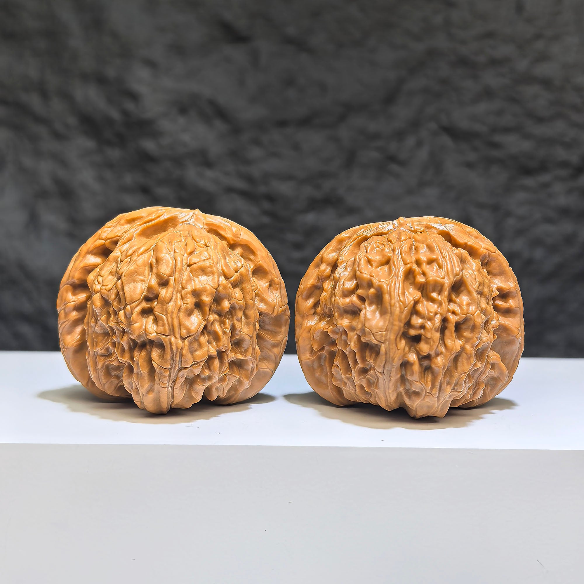 Pair of spherical white lion Wenwan walnuts from Wenwan Art, 43mm x 40mm, featuring detailed white lion carvings in round profile.