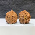 Miniature Wenwan Walnut pair with meteorite inclusions, crafted by Wenwan Art, measuring 31mm x 31mm, showcasing unique natural textures.