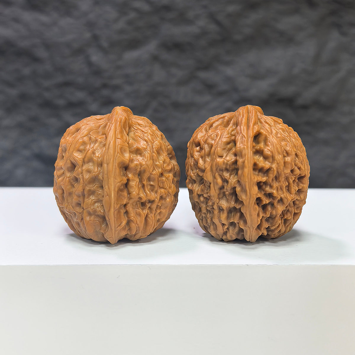 Miniature Wenwan Walnut pair with meteorite inclusions, crafted by Wenwan Art, measuring 31mm x 31mm, showcasing unique natural textures.
