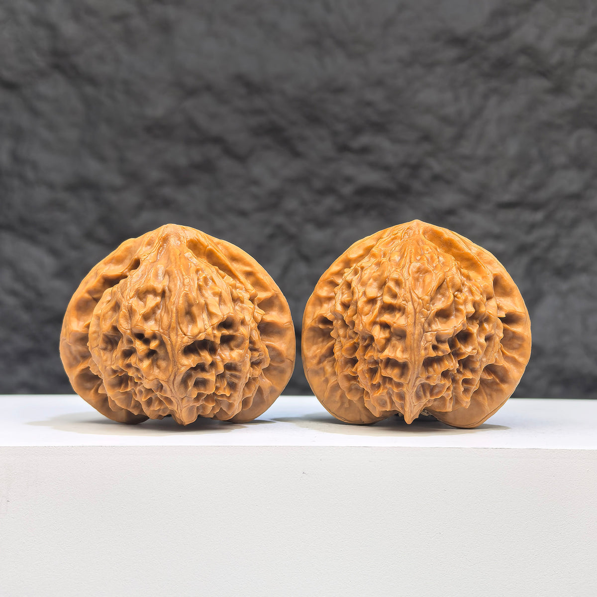 Pair of Peach Heart Palace Lantern Wenwan walnuts by Wenwan Art, featuring carved peach heart designs and smooth polished surfaces.