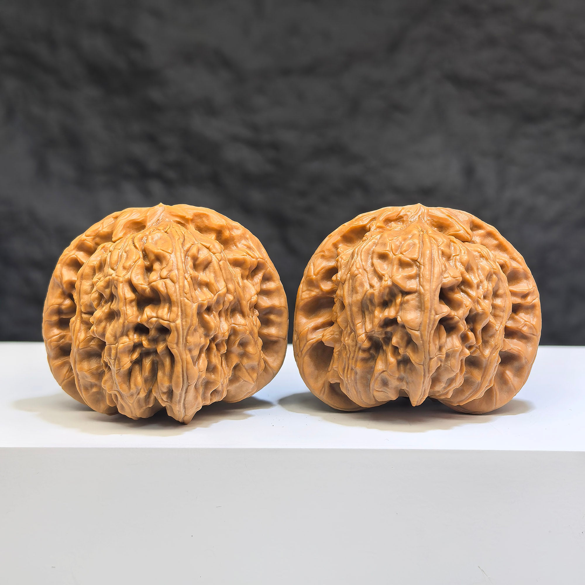 White Lion Wenwan Walnut pair by Wenwan Art, 41mm x 38mm, featuring detailed carvings of lion motifs on smooth, polished walnuts.