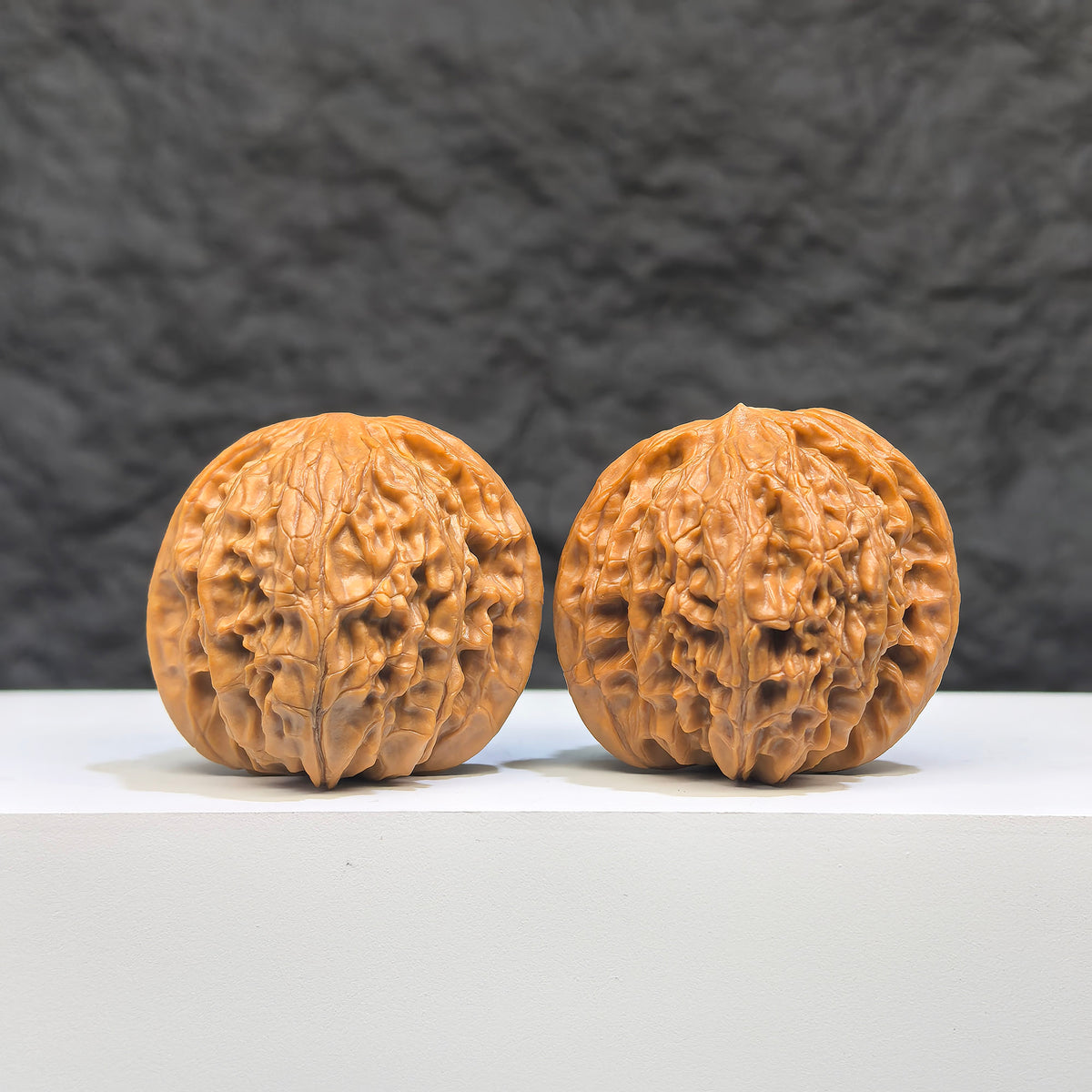 Pair of Wenwan Art Millstone Classic Wenwan Walnuts, 37mm x 34mm, showcasing detailed carvings and natural walnut textures.
