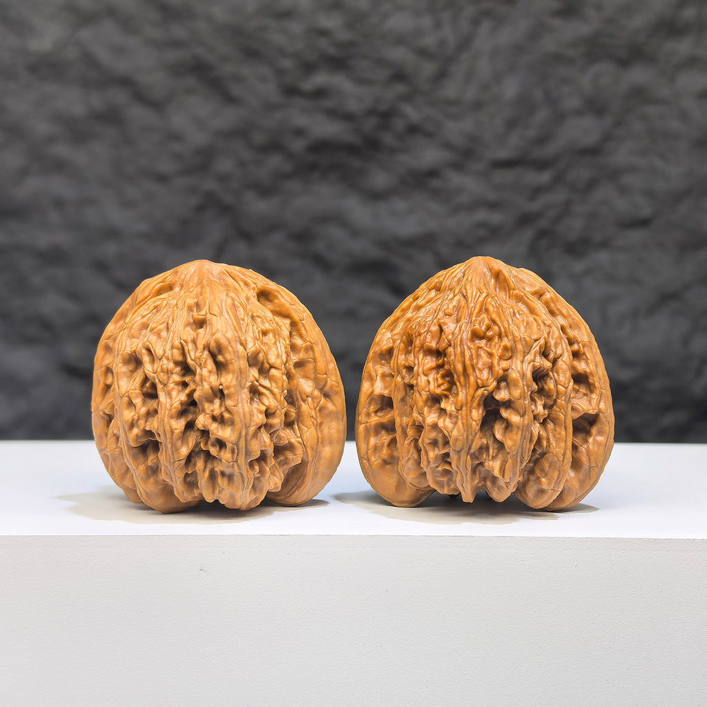 Pair of Yuhua Stone Wenwan walnuts from Wenwan Art, 36mm x 35mm, featuring intricate natural stone patterns and smooth polished surfaces.