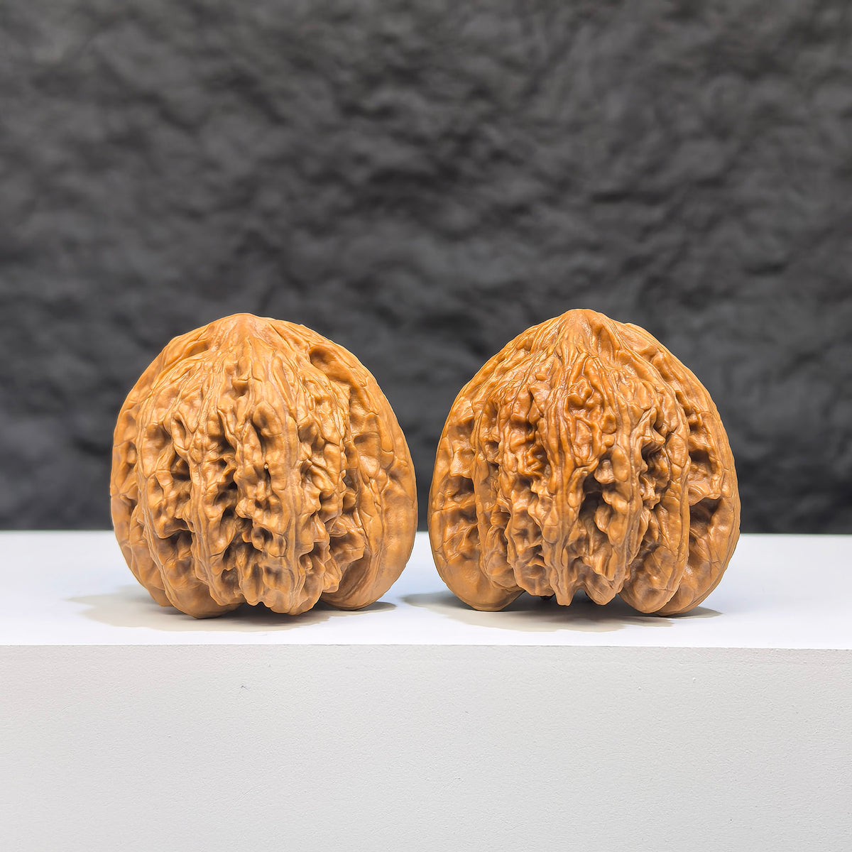 Pair of Yuhua Stone Wenwan walnuts from Wenwan Art, 36mm x 35mm, featuring intricate natural stone patterns and smooth polished surfaces.
