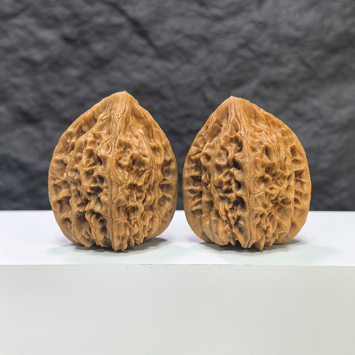 Pair of Beijing Chicken Heart Wenwan walnuts from Wenwan Art, 41mm x 40mm, showcasing smooth, polished walnut carvings.