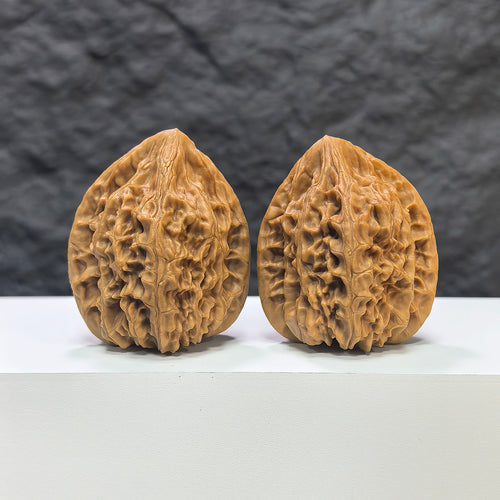 Pair of Beijing Chicken Heart Wenwan walnuts from Wenwan Art, 41mm x 40mm, showcasing smooth, polished walnut carvings.