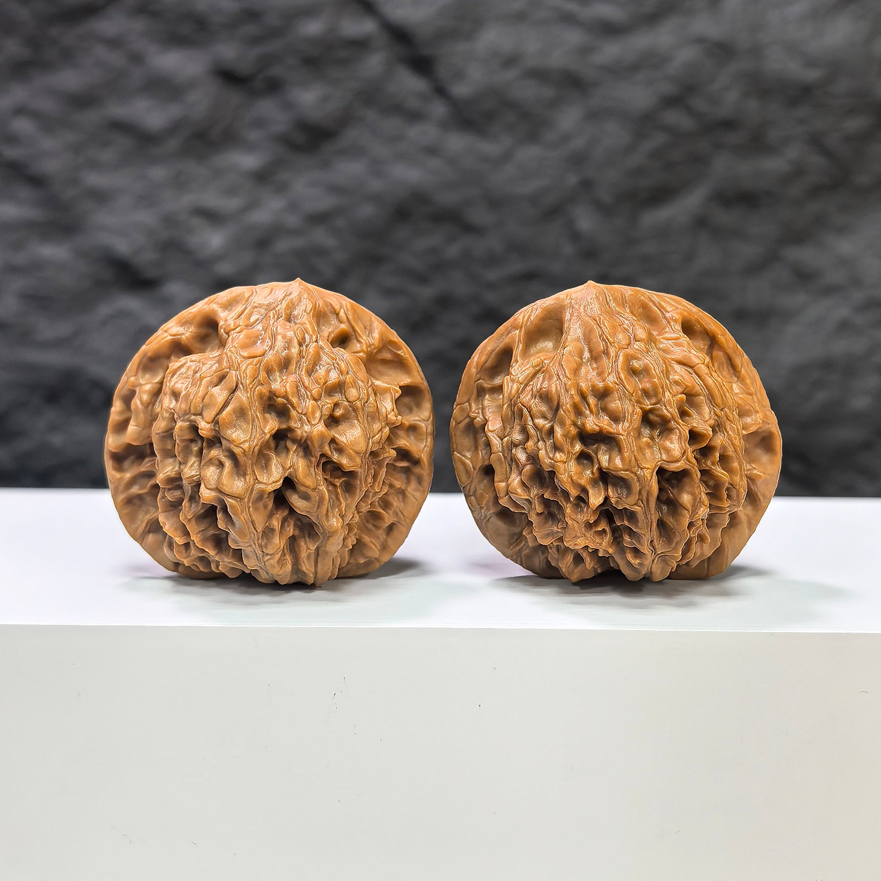 Pair of Golden Kylin Wenwan walnuts from Wenwan Art, featuring intricate carvings on 42mm and 40mm walnuts, collectible art pieces.