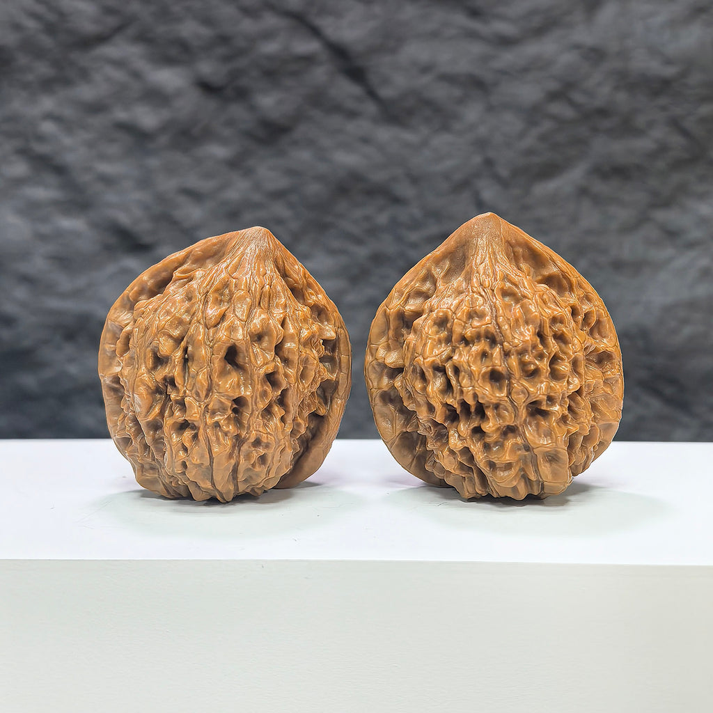 Pair of large Wenwan Art official Wenwan walnuts, 40mm x 36mm, showcasing the smooth, polished surface and natural walnut color.