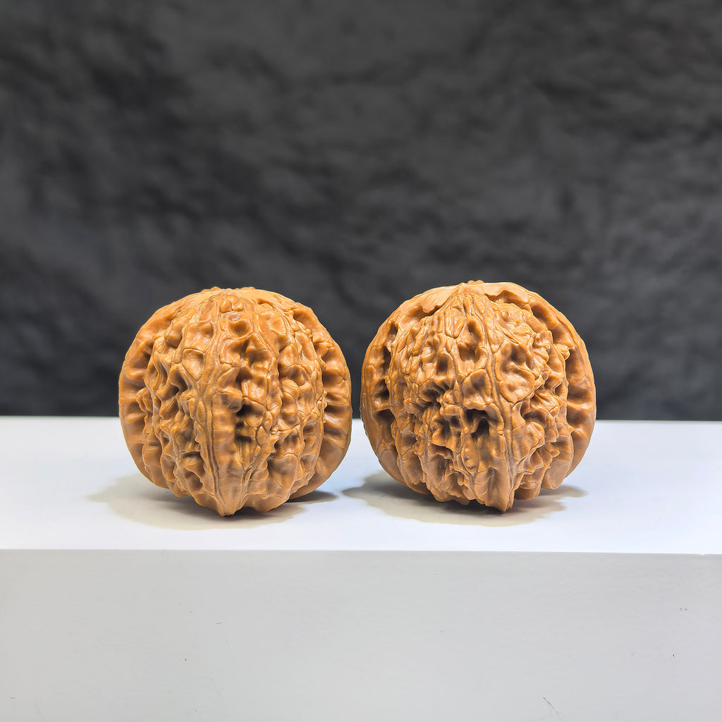 Miniature Wenwan Walnut pair featuring white lion design by Wenwan Art, measuring 32x34mm, in detailed craftsmanship.