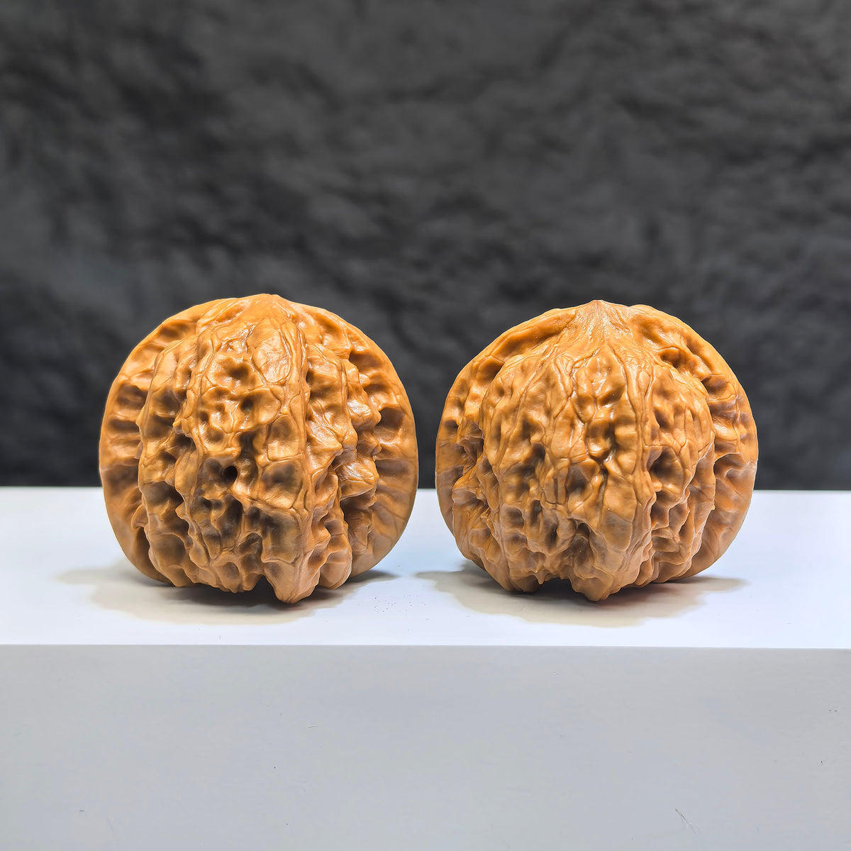 Pair of Wild Wolf Yelang Deep-Carved Wenwan Walnuts from Wenwan Art, featuring intricate carvings, 39mm x 37mm size.