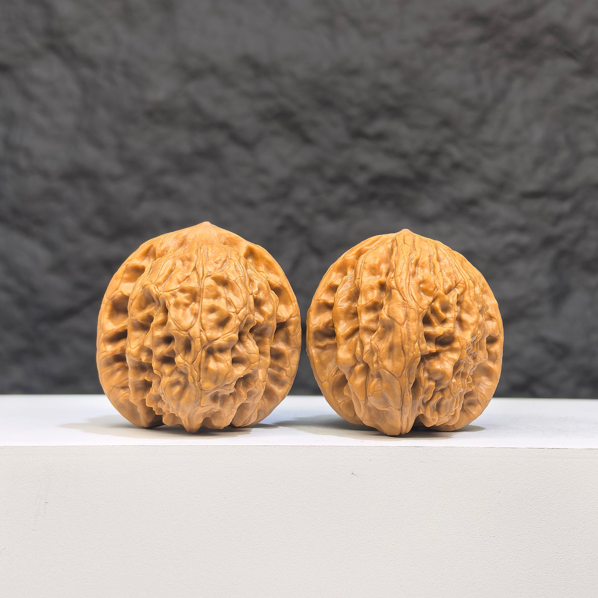 Pair of authentic Wenwan Wild Wolf walnuts by Wenwan Art, 35mm x 37mm, featuring natural wild wolf carvings on smooth walnut surfaces.
