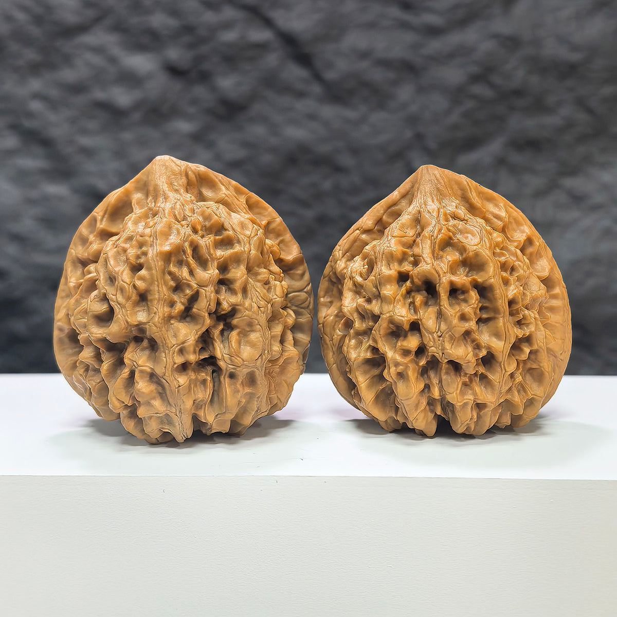 Large Wenwan Art official hat-shaped walnut pair, 47mm x 43mm, showcasing detailed craftsmanship and natural walnut texture.