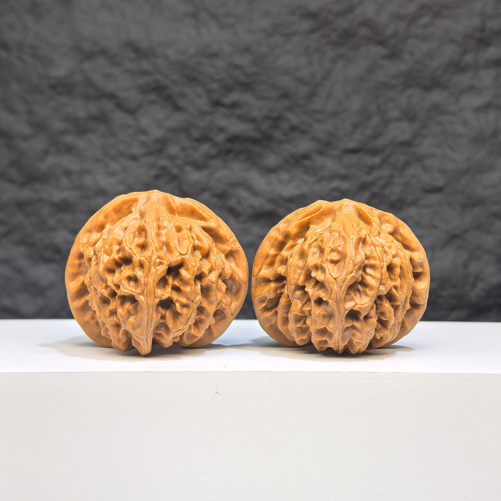Pair of Palace Lantern Wenwan walnuts by Wenwan Art, 42mm x 40mm, featuring intricate carved designs on smooth walnut surfaces.