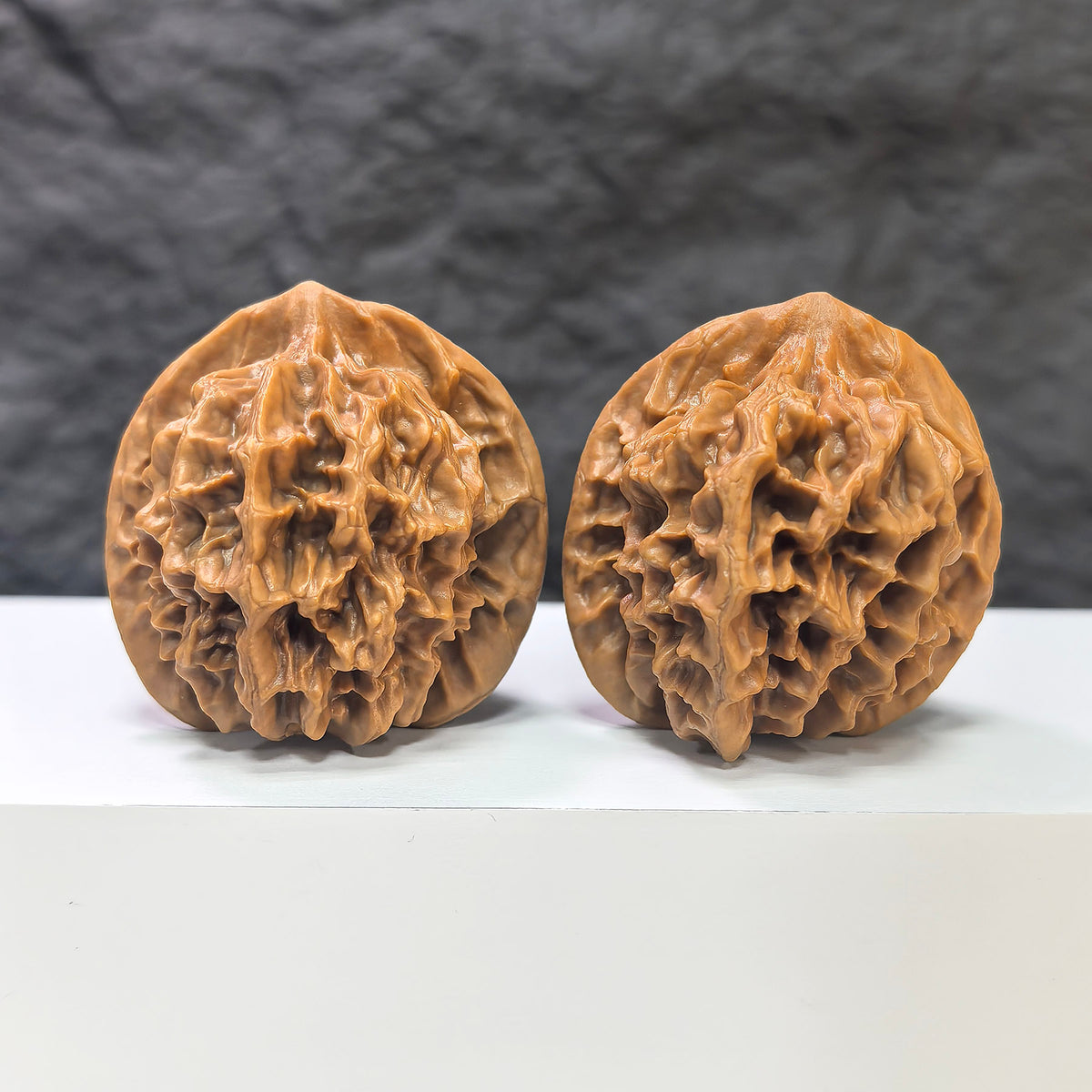 Pair of Emperor Wenwan walnuts from Wenwan Art, 43mm and 42mm, showcasing polished, textured walnut shells with intricate natural patterns.