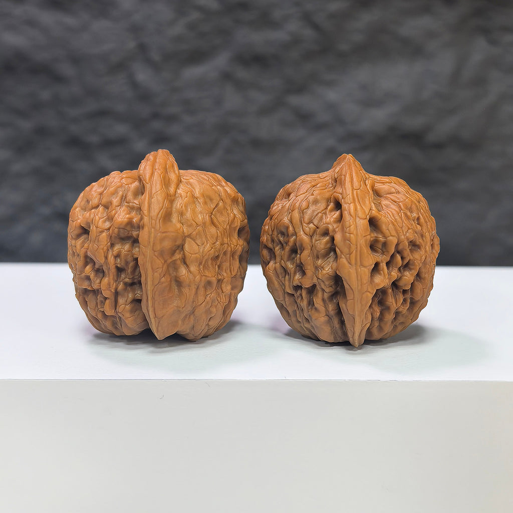 Pair of miniature Wenwan Walnuts featuring pocket meteorite Sycee carvings, crafted by Wenwan Art, measuring approximately 30mm by 31mm.