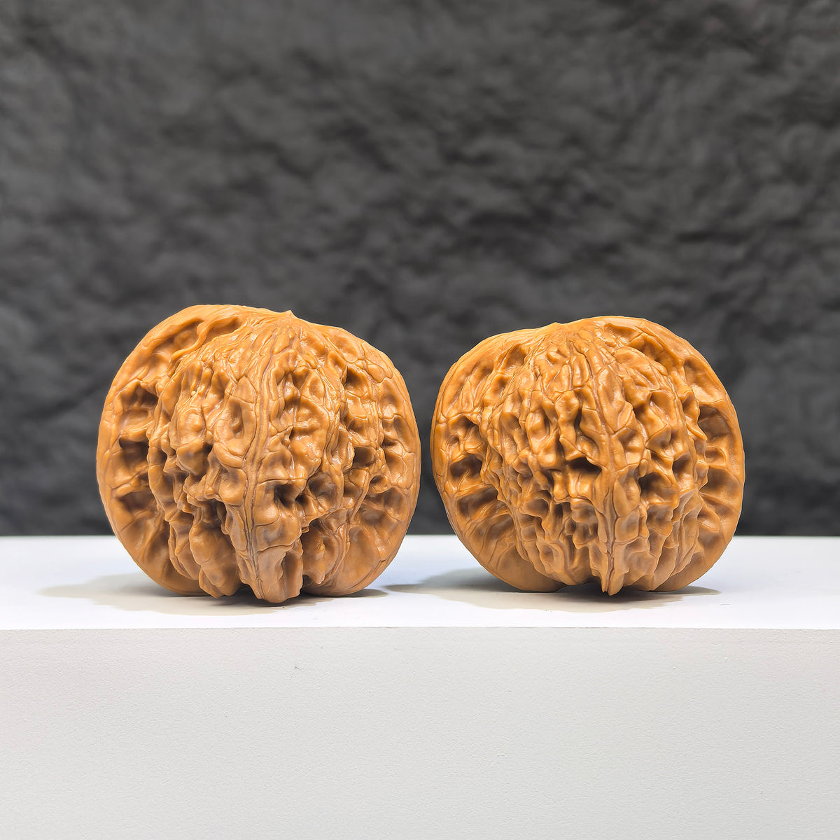 Close-up of a Butterfly Millstone Wenwan Walnut by Wenwan Art, showing detailed butterfly pattern on a 38mm x 37mm walnut piece.
