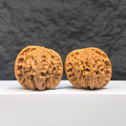 Close-up of a Butterfly Millstone Wenwan Walnut by Wenwan Art, showing detailed butterfly pattern on a 38mm x 37mm walnut piece.