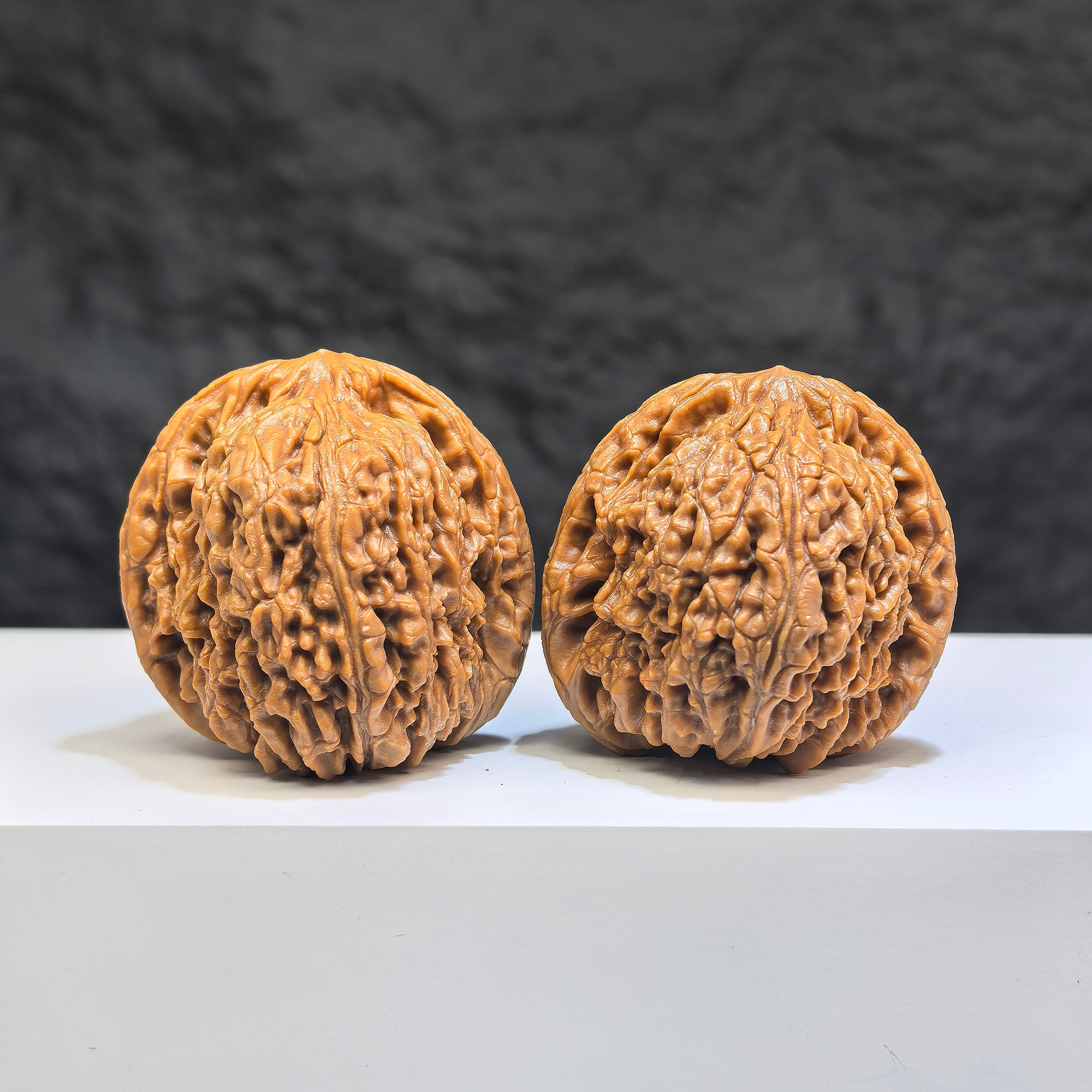 Pair of Nanjiangstone Wenwan walnuts by Wenwan Art, 37mm each, featuring natural stone texture and detailed carving.