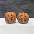 Pair of Nuwa Stone Wenwan walnuts from Wenwan Art, 38mm x 37mm, showcasing natural stone texture and craftsmanship.