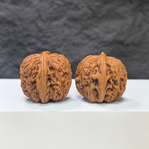 Pair of Nuwa Stone Wenwan walnuts from Wenwan Art, 38mm x 37mm, showcasing natural stone texture and craftsmanship.