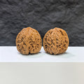 Pair of Nanjiangstone Wenwan walnuts by Wenwan Art, 36mm x 34mm, showcasing detailed natural stone textures and craftsmanship.