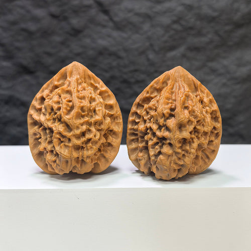 Pair of Wenwan Art "Classic Scholar" hand-matched Wenwan walnuts with 麒麟紋 pattern, 43mm x 40mm, detailed natural wood grain.