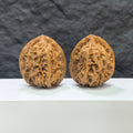 Pair of Wenwan Art Arhat Head round-profile Wenwan walnuts, 41mm x 38mm, showing detailed carved walnut with natural wood grain.
