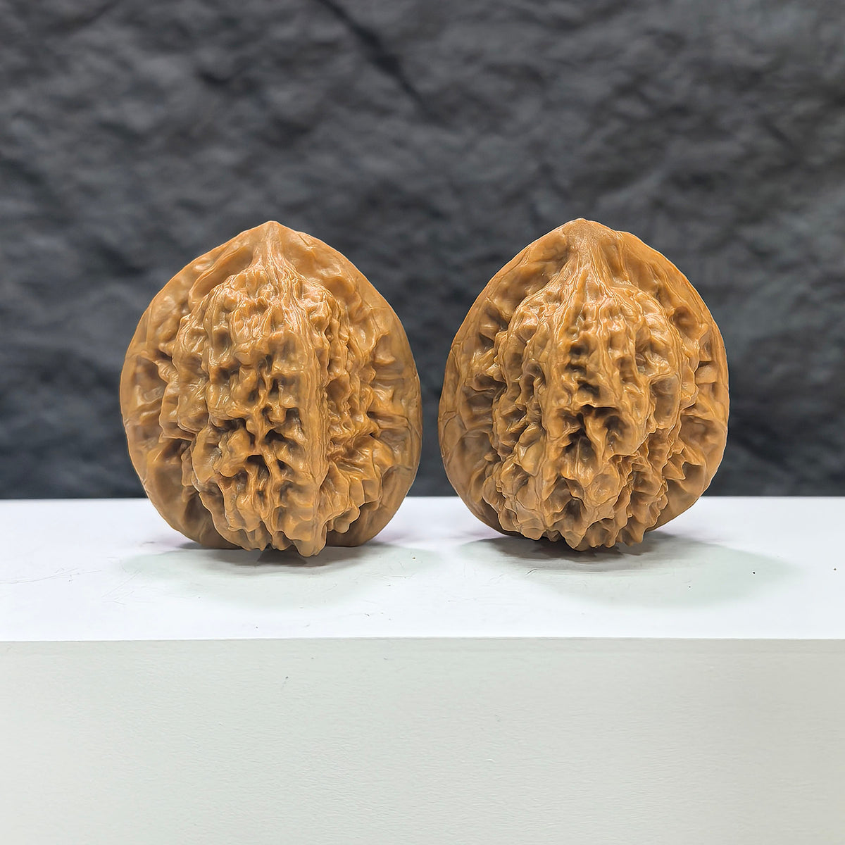 Pair of Wenwan Art Arhat Head round-profile Wenwan walnuts, 41mm x 38mm, showing detailed carved walnut with natural wood grain.