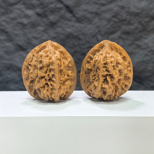 Pair of Wenwan Art Arhat Head round-profile Wenwan walnuts, 41mm x 38mm, showing detailed carved walnut with natural wood grain.