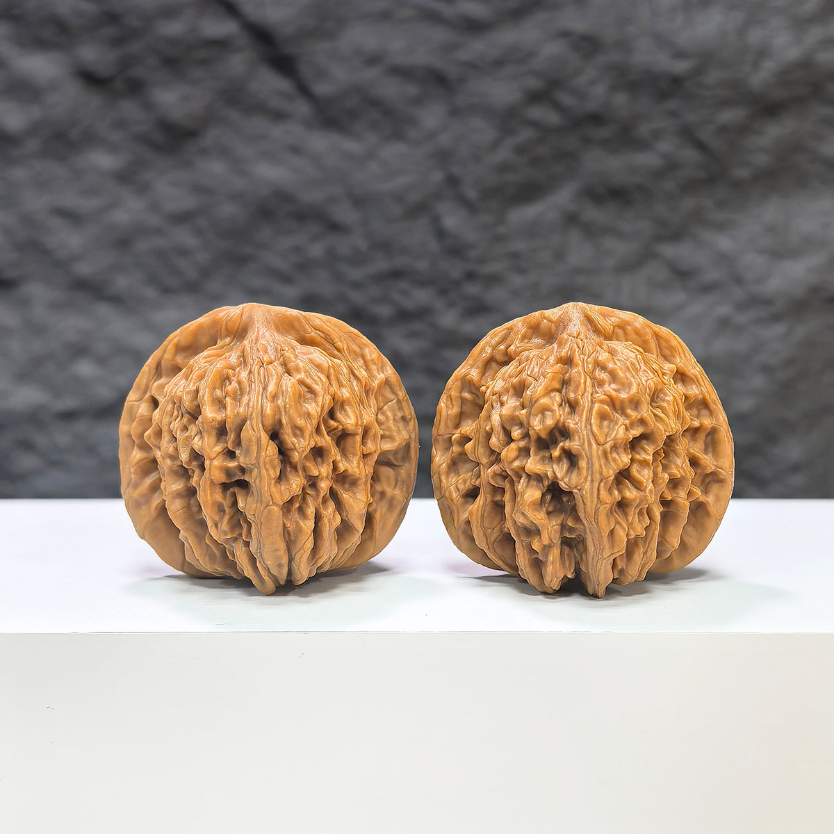 Pair of Sizuolou Wenwan Walnuts by Wenwan Art, 39mm x 37mm, showcasing detailed carved walnut art on a neutral background.
